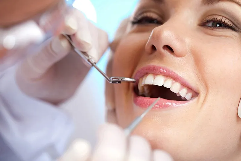 Hygienist examining a patient's teeth